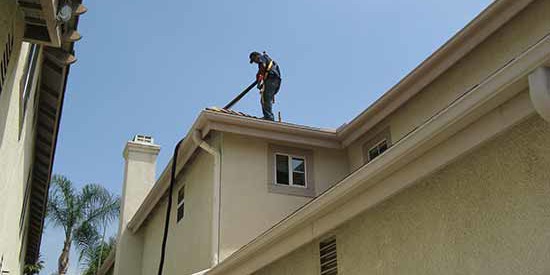 residential gutter cleaning professional on roof